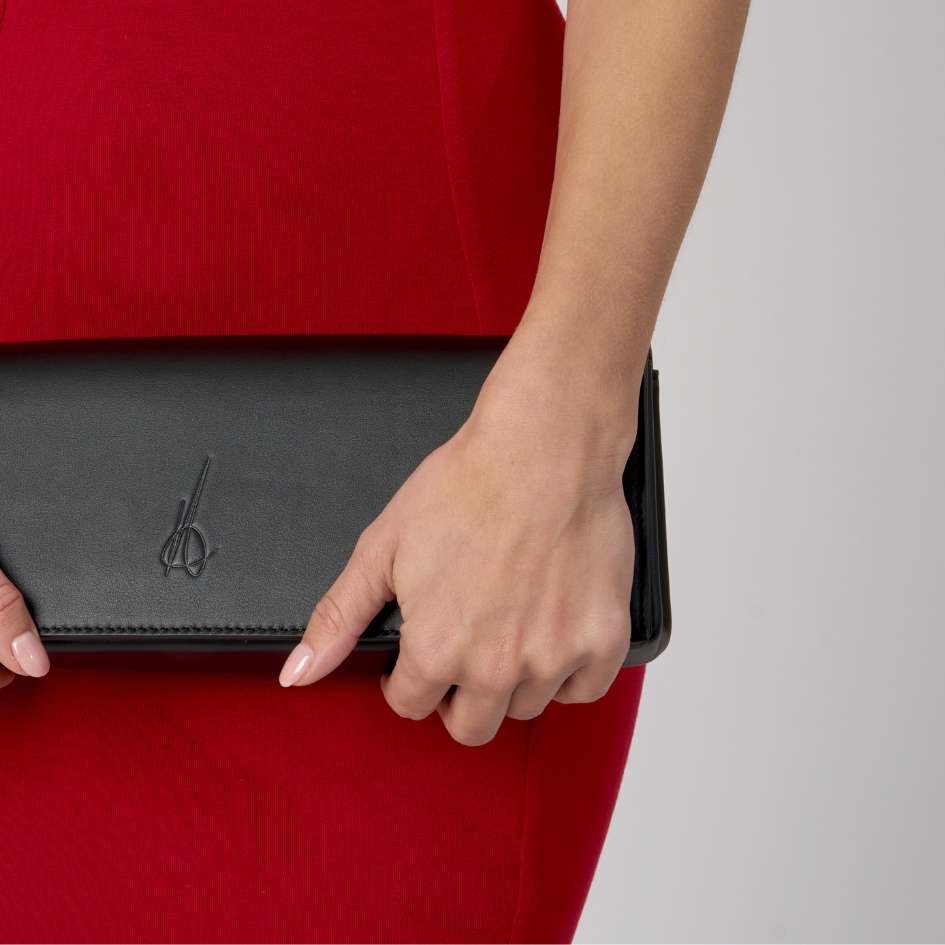 The Aurora Bella clutch bag held by a woman