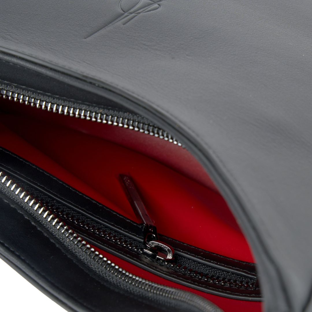 Black handbag with a red interior closeup