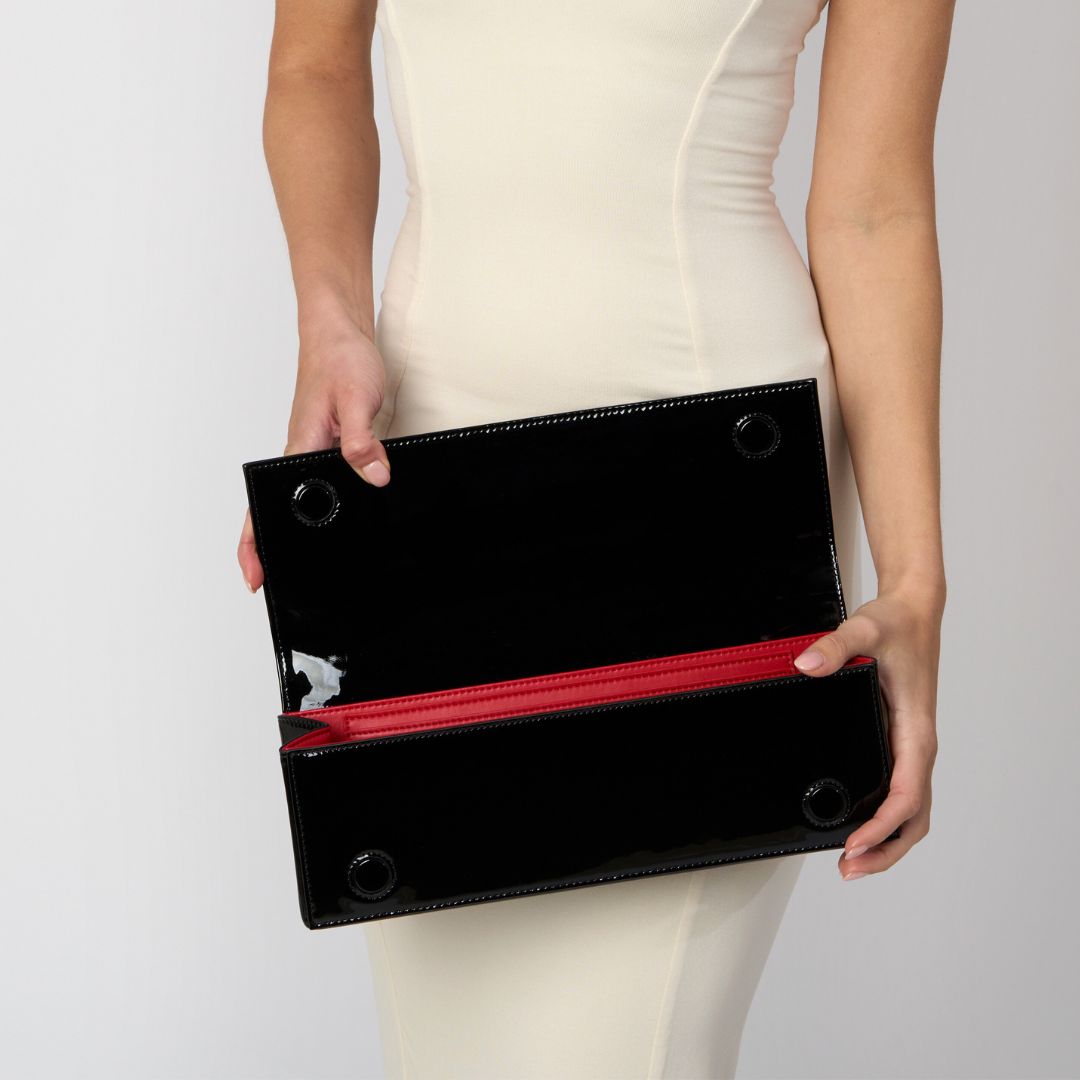 a black patent clutch bag with a red interior #colour_black - patent