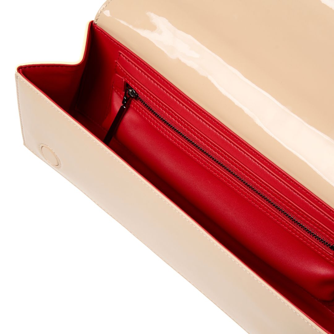 a nude patent womans clutch bag with a red interior #colour_nude - patent