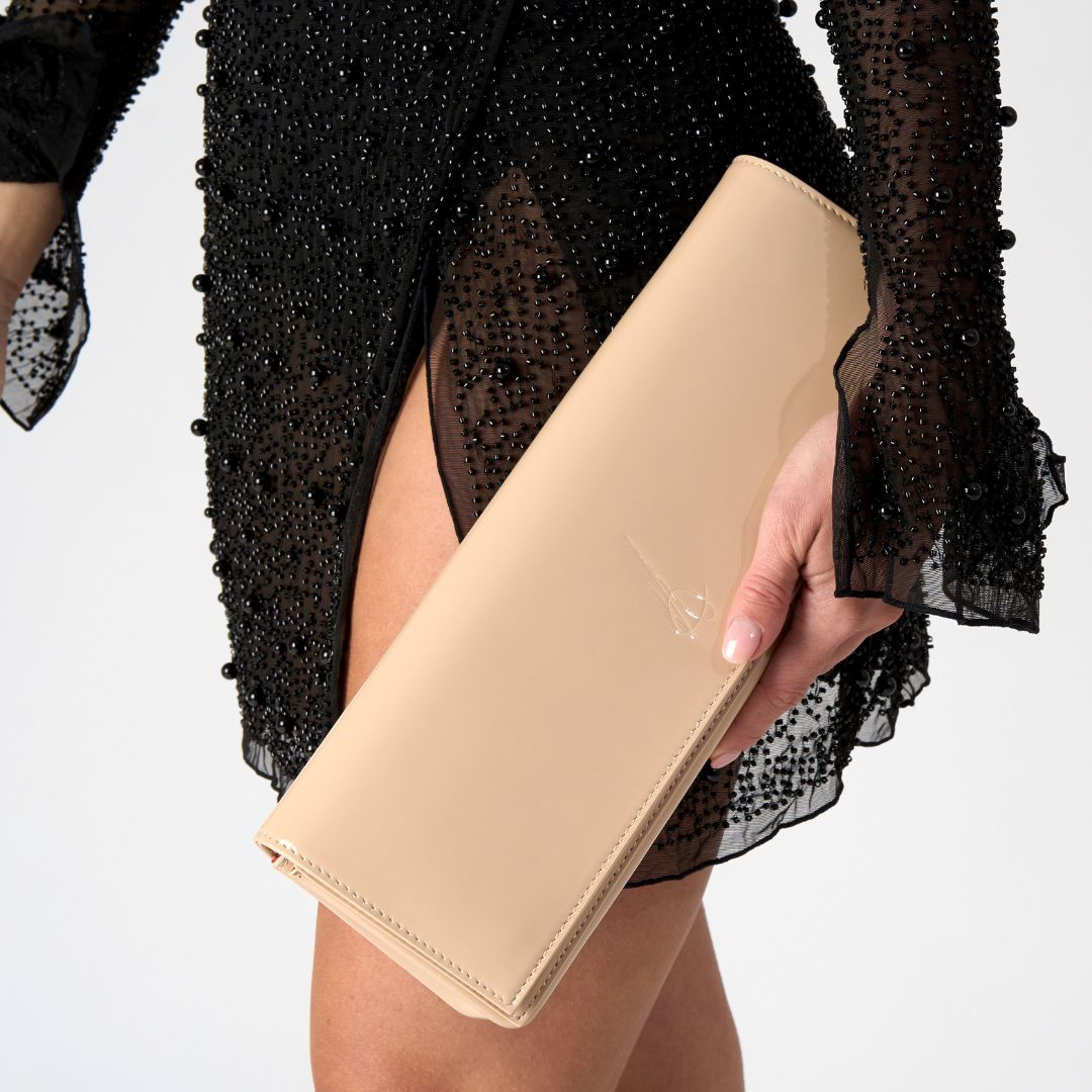 front side of a nude colour patent clutch bag #colour_nude - patent